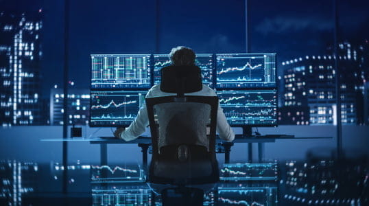 Utilizing StoneX Pro platforms, a financial analyst reviews market data across screens, managing 100+ liquidity relationships