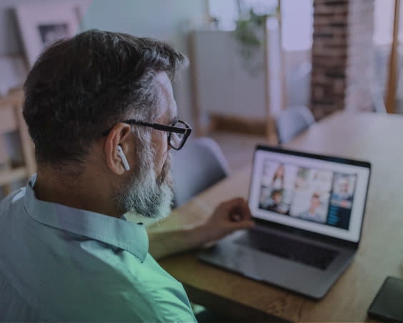Man watching webinar on laptop