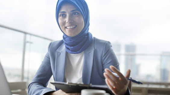 Smiling lady holding clipboard and pen