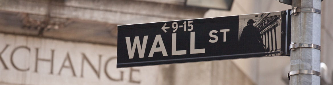 Trading floor 2 Wall Street sign with a building in background